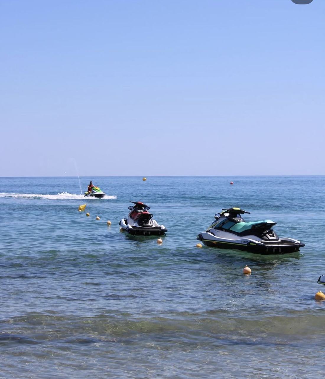 Jet skis moored in front of the resort beach